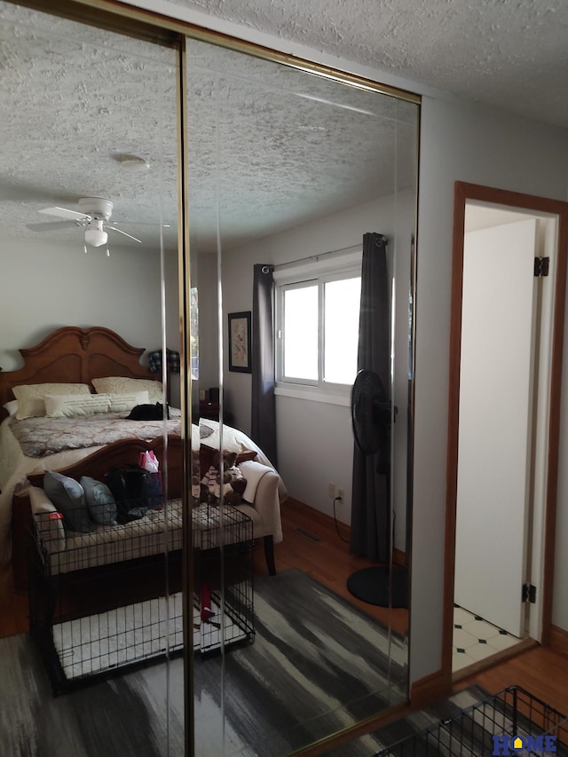 bedroom featuring hardwood / wood-style flooring and a textured ceiling