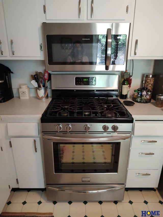 kitchen featuring appliances with stainless steel finishes and white cabinets