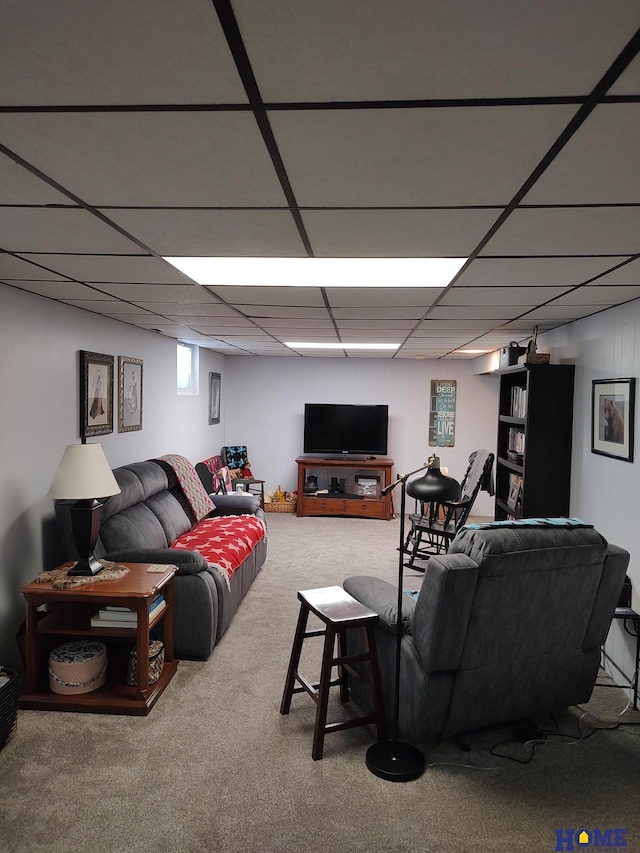 carpeted living room featuring a paneled ceiling