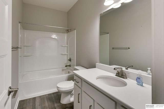 full bathroom featuring hardwood / wood-style flooring, vanity, toilet, and tub / shower combination