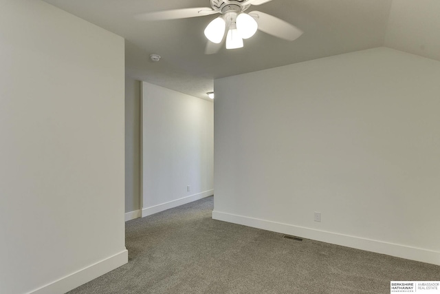 carpeted spare room with ceiling fan and lofted ceiling