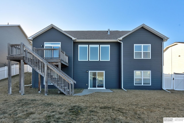 back of property featuring a yard and a deck