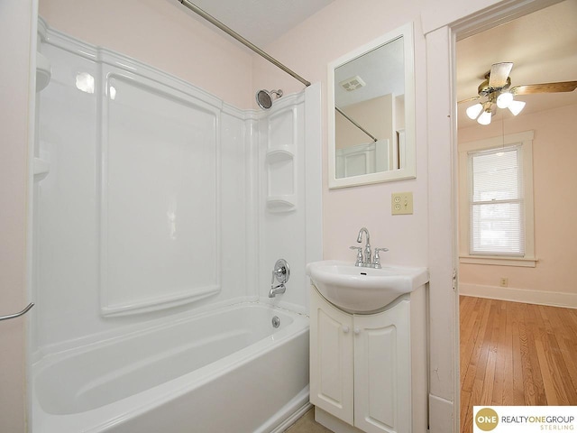 bathroom featuring vanity, ceiling fan, shower / tub combination, and wood-type flooring