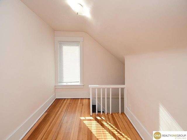 bonus room featuring lofted ceiling and light hardwood / wood-style floors