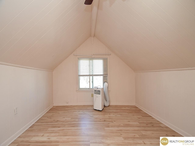 bonus room featuring light hardwood / wood-style flooring and lofted ceiling with beams