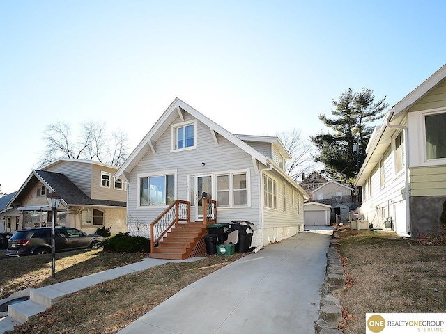 view of front of property featuring a garage and an outdoor structure