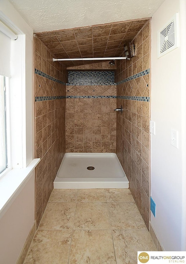 bathroom with a tile shower