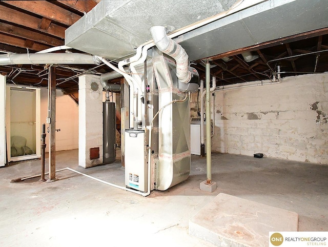 basement featuring water heater and washer / clothes dryer