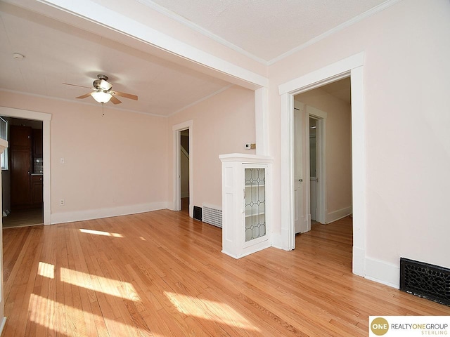 unfurnished room featuring ornamental molding, light hardwood / wood-style floors, and ceiling fan