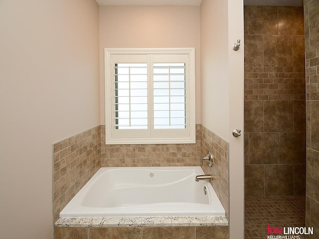 bathroom with tiled bath