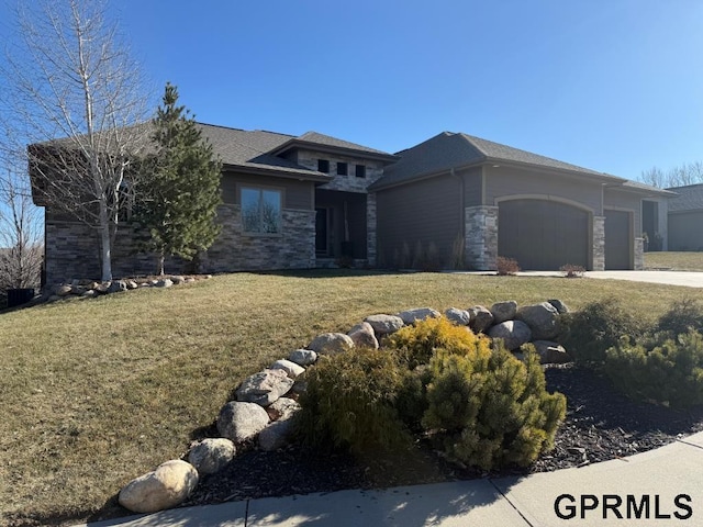 prairie-style home with a garage and a front lawn