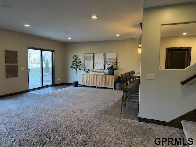 living room with dark colored carpet