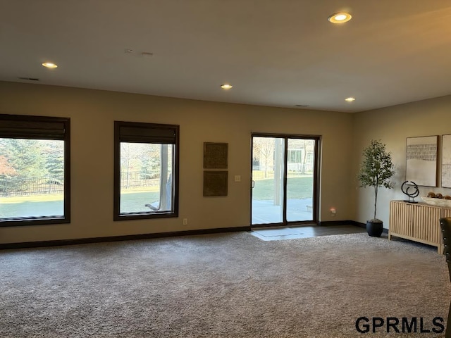 empty room featuring radiator and carpet