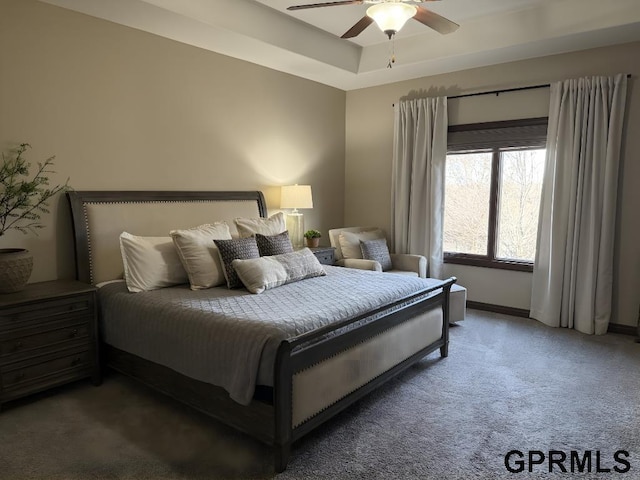 bedroom with ceiling fan and dark carpet