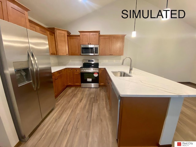 kitchen with appliances with stainless steel finishes, sink, light hardwood / wood-style flooring, and decorative light fixtures