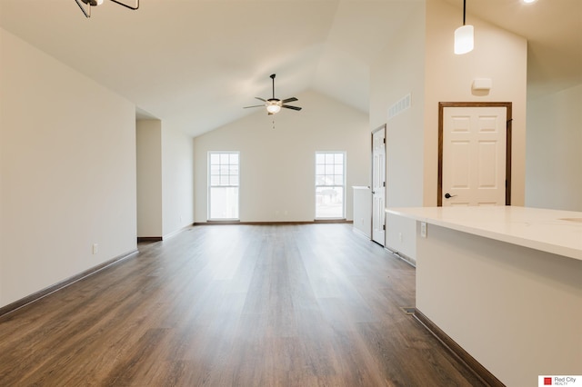 unfurnished living room featuring dark wood-type flooring, ceiling fan, and high vaulted ceiling