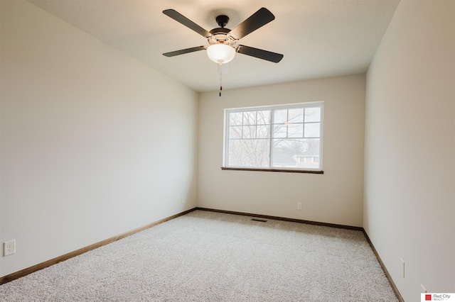 carpeted spare room with ceiling fan