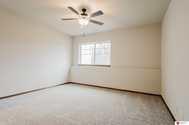 spare room featuring carpet flooring and ceiling fan