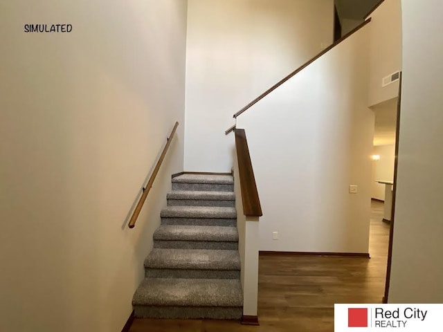 stairway with hardwood / wood-style flooring