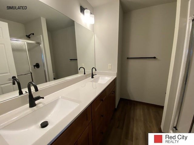 bathroom with vanity, hardwood / wood-style floors, and an enclosed shower