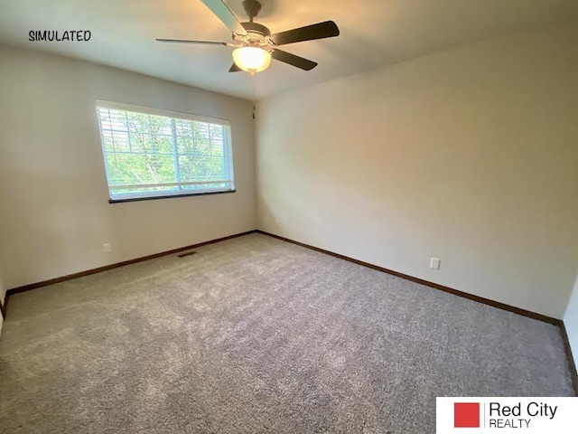 carpeted spare room featuring ceiling fan