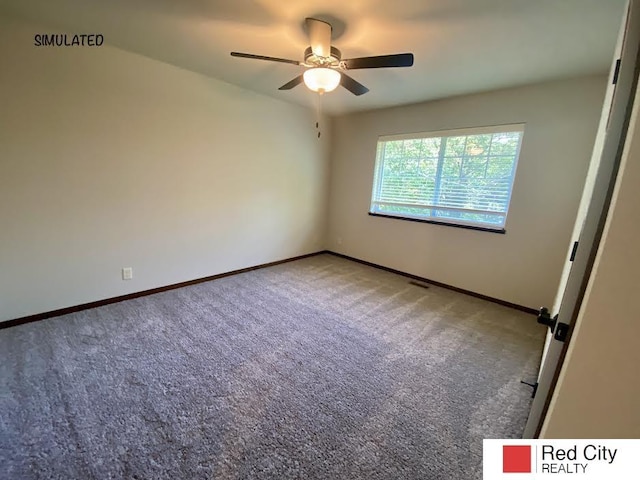 carpeted spare room with ceiling fan