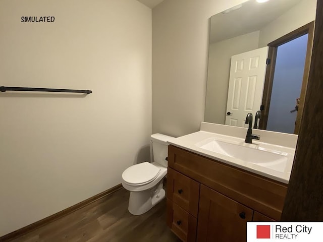 bathroom with vanity, wood-type flooring, and toilet