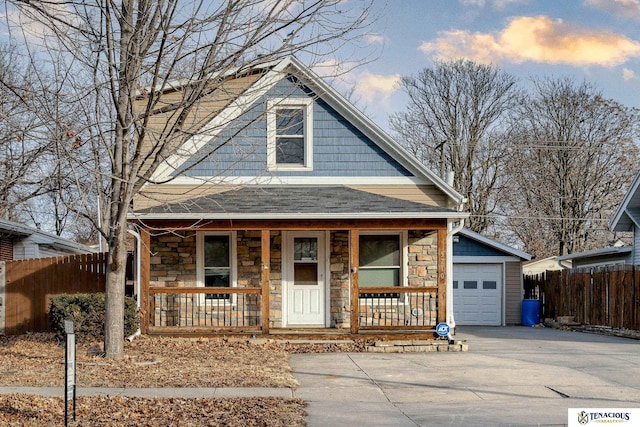 view of front of home featuring a porch and a garage