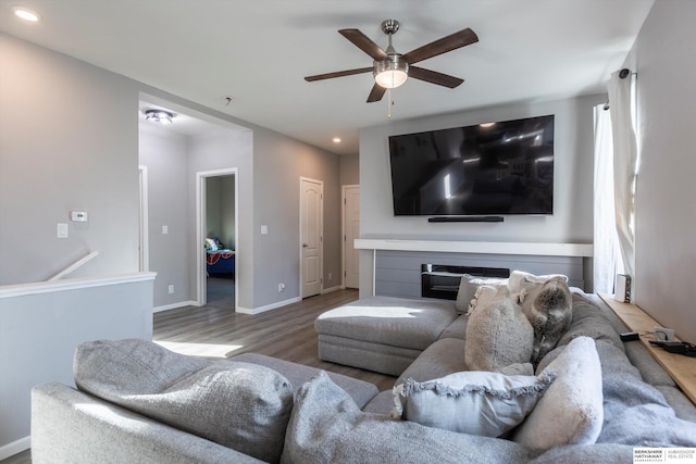 living room featuring ceiling fan and hardwood / wood-style floors