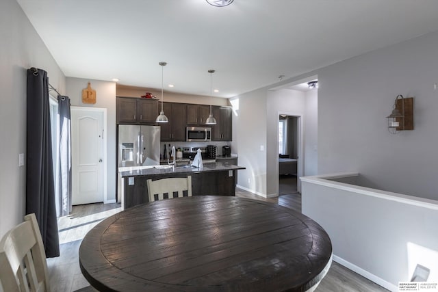 dining room featuring sink and light wood-type flooring