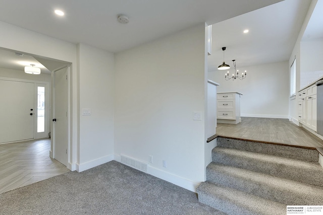 stairway featuring parquet floors