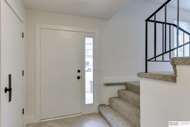 foyer featuring a healthy amount of sunlight and light parquet floors