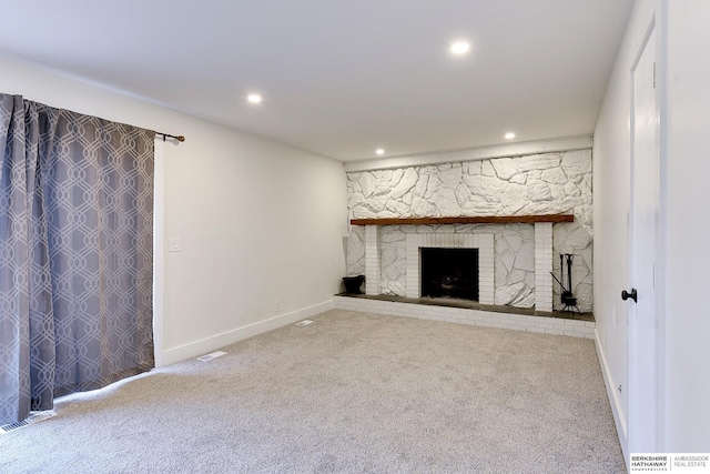 unfurnished living room with a fireplace and carpet flooring