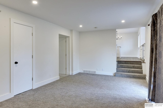 basement with carpet floors and a chandelier