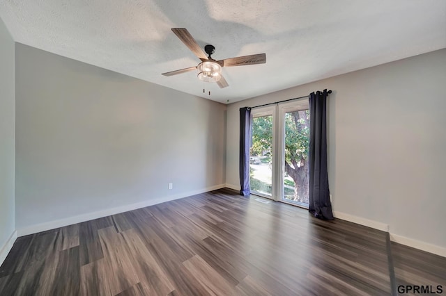 empty room featuring ceiling fan, a textured ceiling, and dark hardwood / wood-style flooring