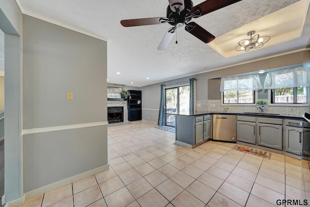 kitchen featuring gray cabinets, stainless steel dishwasher, light tile patterned floors, and decorative backsplash