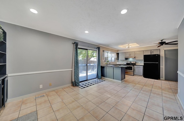 kitchen with light tile patterned floors, stainless steel electric range, gray cabinetry, backsplash, and black fridge