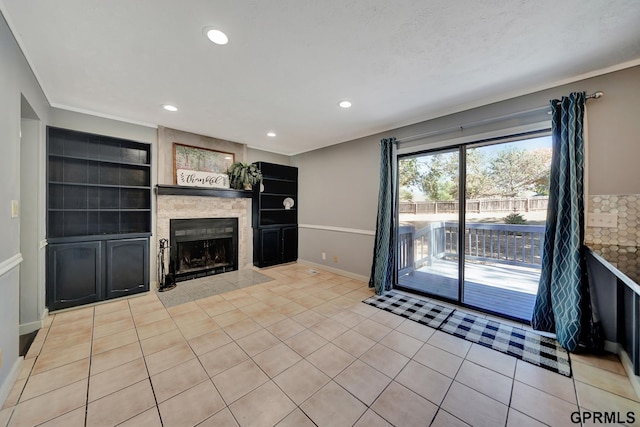 unfurnished living room with built in shelves, a tile fireplace, and light tile patterned floors