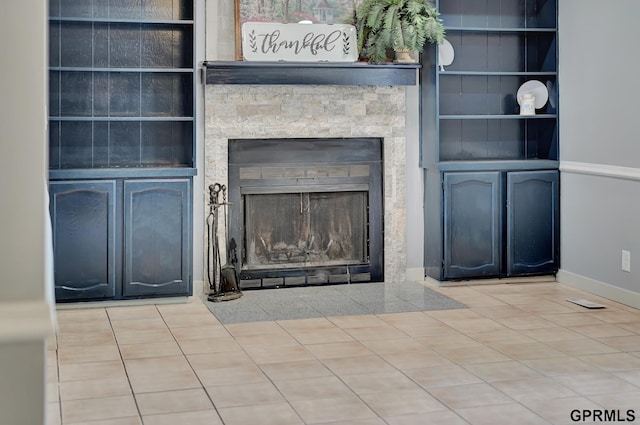 details with built in shelves and a stone fireplace