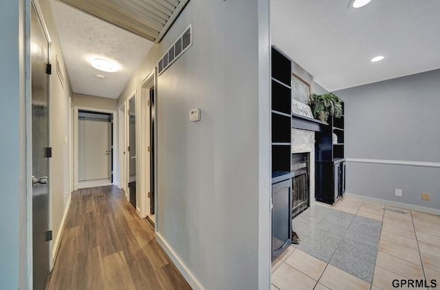 corridor featuring light tile patterned floors