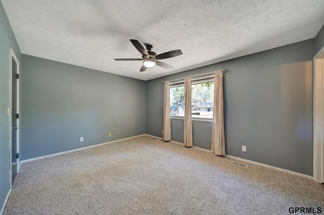 spare room with ceiling fan, carpet floors, and a textured ceiling