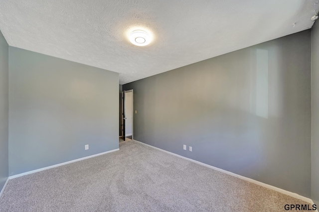 carpeted spare room with a textured ceiling