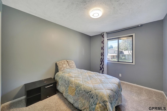 bedroom featuring carpet flooring and a textured ceiling