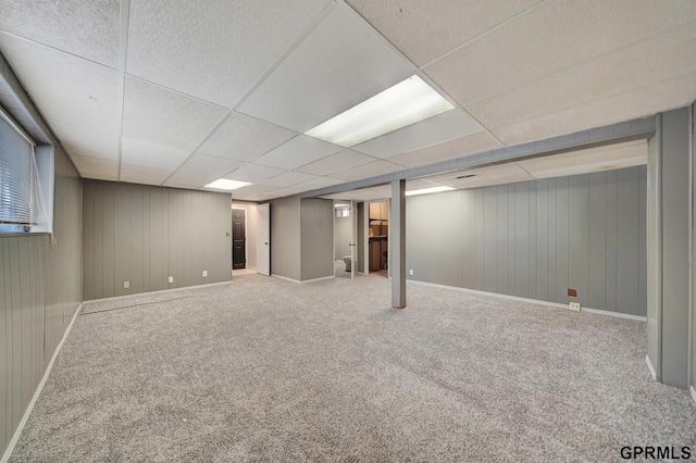 basement with carpet floors and a paneled ceiling