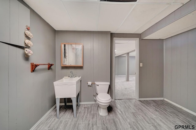 bathroom with hardwood / wood-style flooring and toilet