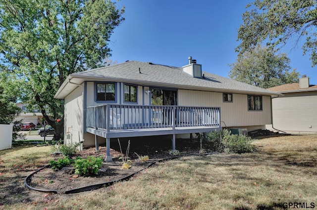 back of property featuring a yard and a deck