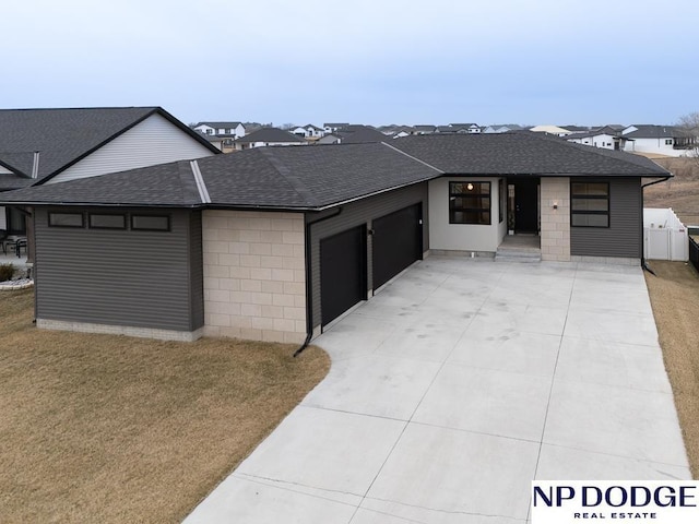 view of front facade with a garage and a front lawn