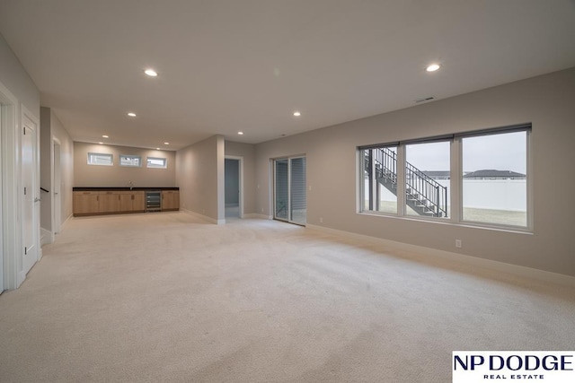 interior space featuring wine cooler and light colored carpet