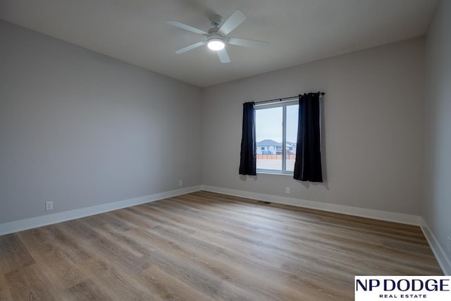 spare room with ceiling fan and light wood-type flooring