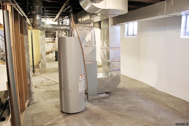 basement featuring heating unit and water heater